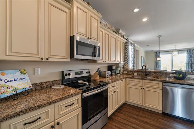 219 Sombrero Beach Rd Unit 2, Marathon, FL 33050 - kitchen featuring stainless steel appliances, dark wood-type flooring, dark stone countertops, cream cabinets, and a sink