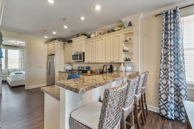 219 Sombrero Beach Rd Unit 2, Marathon, FL 33050 - kitchen with dark wood finished floors, visible vents, crown molding, and appliances with stainless steel finishes