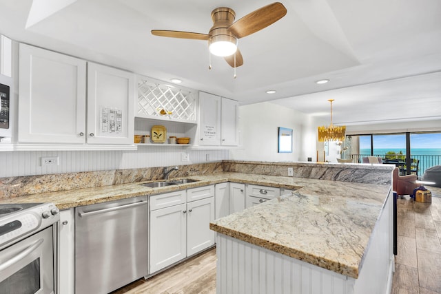 1133 Ocean Dr Unit 4, Marathon, FL 33050 - kitchen featuring stainless steel appliances, a sink, light wood-type flooring, white cabinets, and recessed lighting