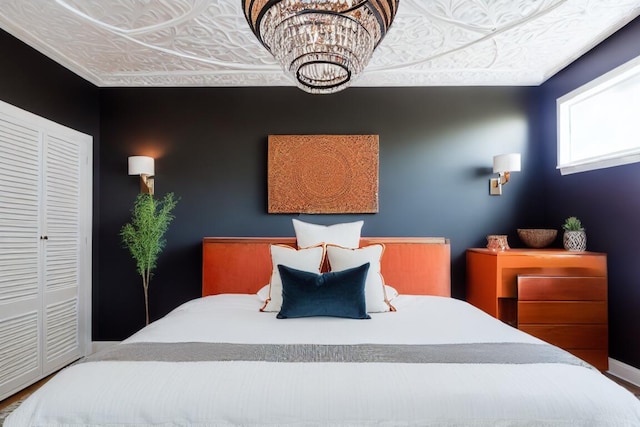 bedroom featuring a chandelier and a closet