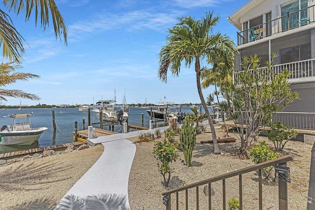 exterior space featuring a boat dock, a water view, and boat lift