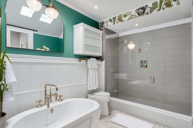 full bathroom featuring toilet, a wainscoted wall, a shower stall, and a skylight