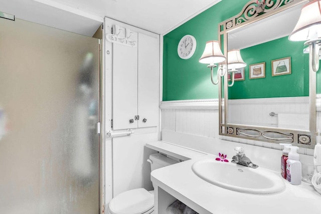 full bath featuring wainscoting, vanity, and toilet