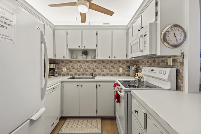1101 Ocean Dr Unit 29, Key Colony, FL 33051 - kitchen with white appliances, a ceiling fan, light countertops, tasteful backsplash, and light wood-style floors