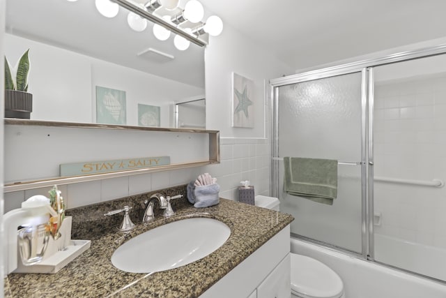 1101 Ocean Dr Unit 29, Key Colony, FL 33051 - bathroom featuring vanity, tile walls, and combined bath / shower with glass door