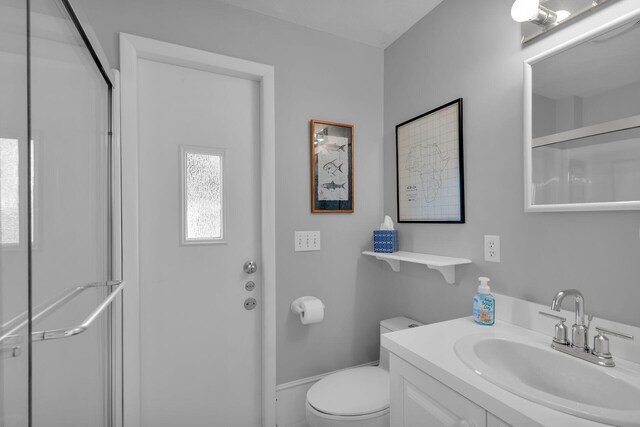 full bathroom with toilet, an enclosed shower, and vanity