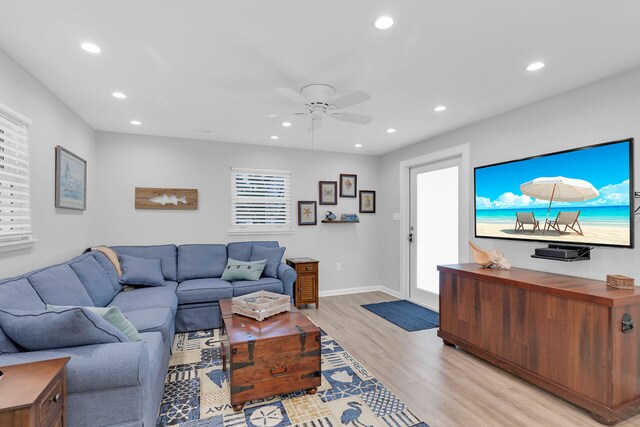 living room featuring recessed lighting, baseboards, a ceiling fan, and light wood finished floors