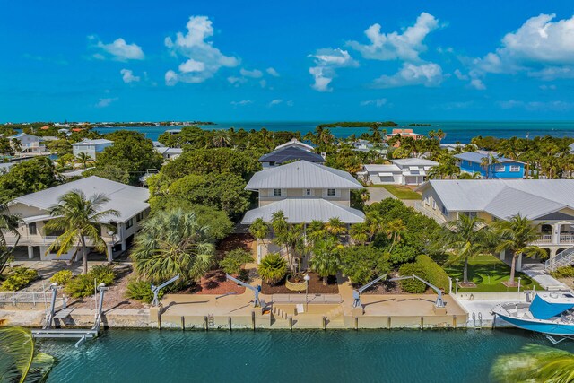 drone / aerial view featuring a residential view and a water view