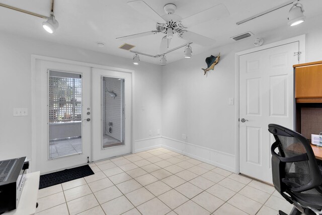 interior space with a ceiling fan, visible vents, baseboards, light tile patterned flooring, and french doors