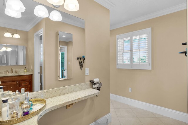 bathroom with tile patterned floors, baseboards, ornamental molding, and vanity