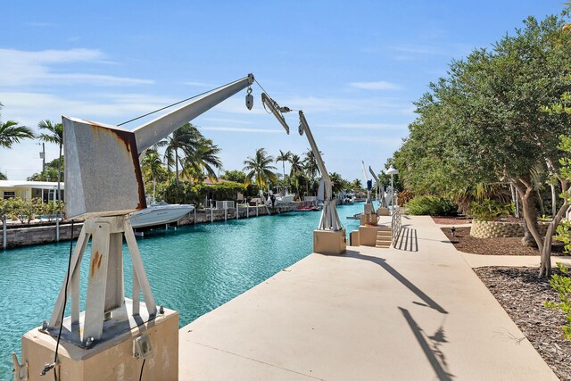 view of pool featuring a boat dock and a water view