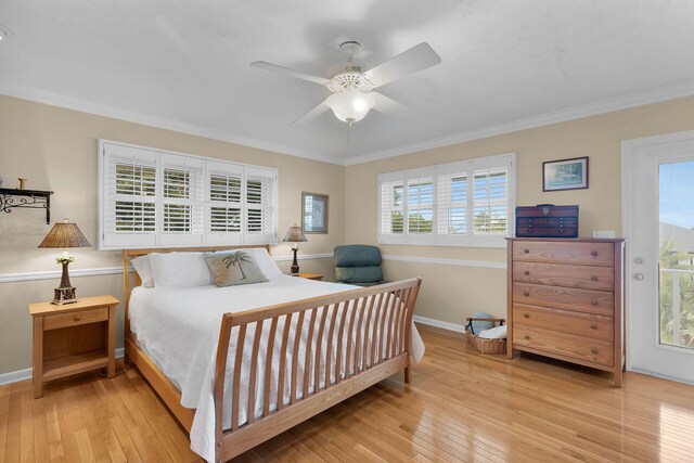 bedroom with ceiling fan, baseboards, wood-type flooring, and ornamental molding