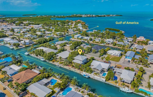 bird's eye view featuring a water view and a residential view