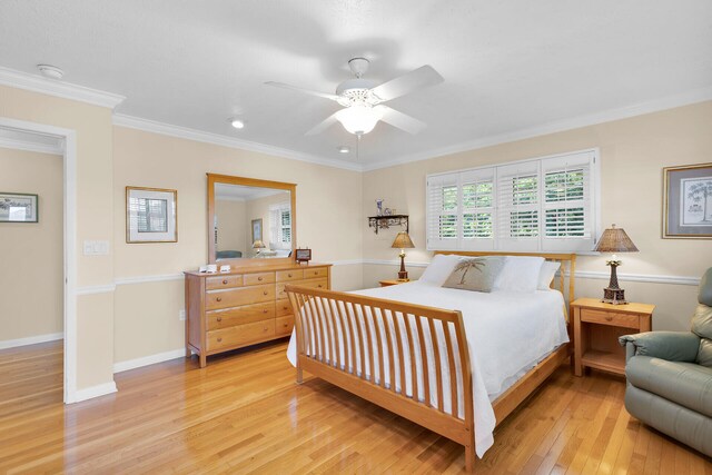 bedroom featuring ceiling fan, baseboards, ornamental molding, and light wood finished floors