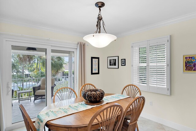 dining room featuring light tile patterned flooring, crown molding, and baseboards