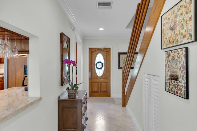 entryway with visible vents, light tile patterned flooring, crown molding, baseboards, and stairs