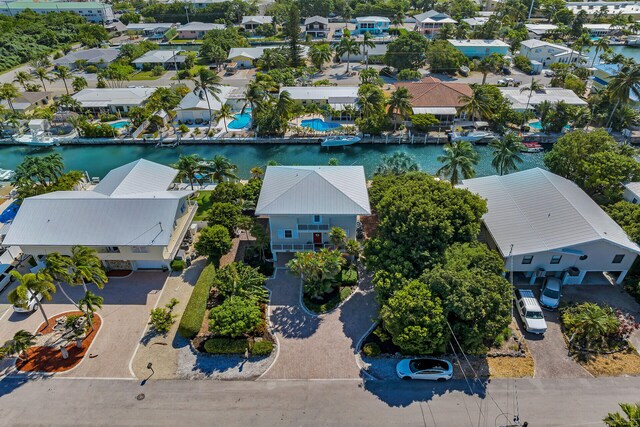 drone / aerial view with a residential view and a water view