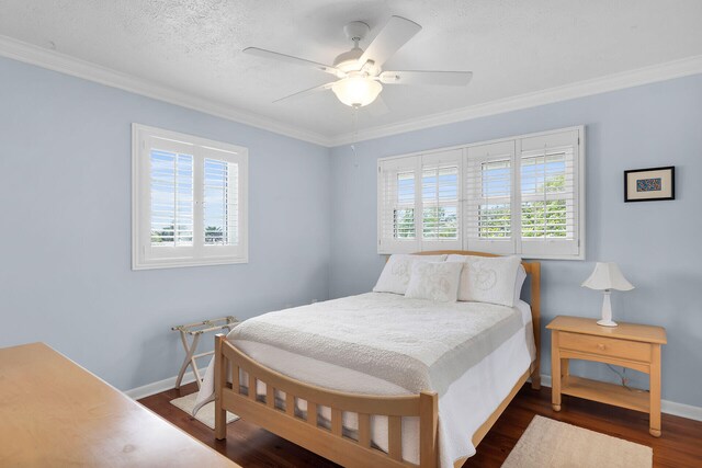 bedroom with multiple windows, ornamental molding, baseboards, and dark wood-style flooring