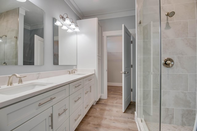 335 Pirates Rd, Little Torch, FL 33042 - bathroom with tiled shower, double vanity, wood finished floors, crown molding, and a walk in closet