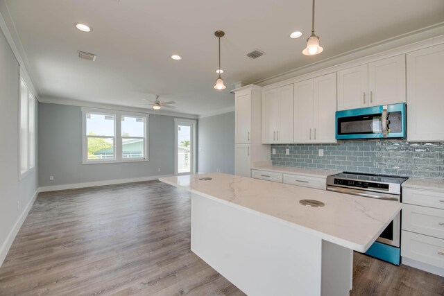 335 Pirates Rd, Little Torch, FL 33042 - kitchen featuring stainless steel appliances, crown molding, decorative backsplash, open floor plan, and a center island