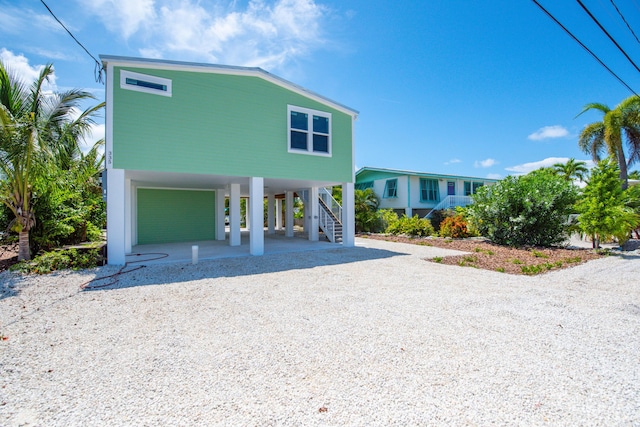 335 Pirates Rd, Little Torch, FL 33042 - raised beach house featuring a carport, stairway, and driveway