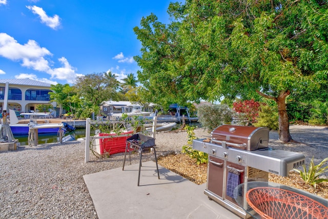 30985 Hibiscus Dr, Big Pine, FL 33043 - view of patio / terrace featuring a grill, a dock, and a water view