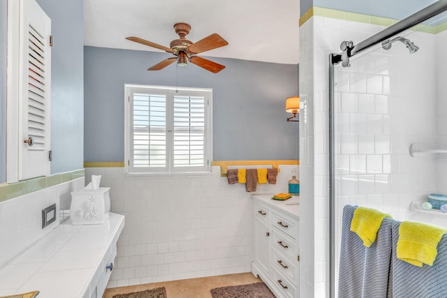 30985 Hibiscus Dr, Big Pine, FL 33043 - full bathroom featuring tile walls, vanity, ceiling fan, a tile shower, and tile patterned flooring