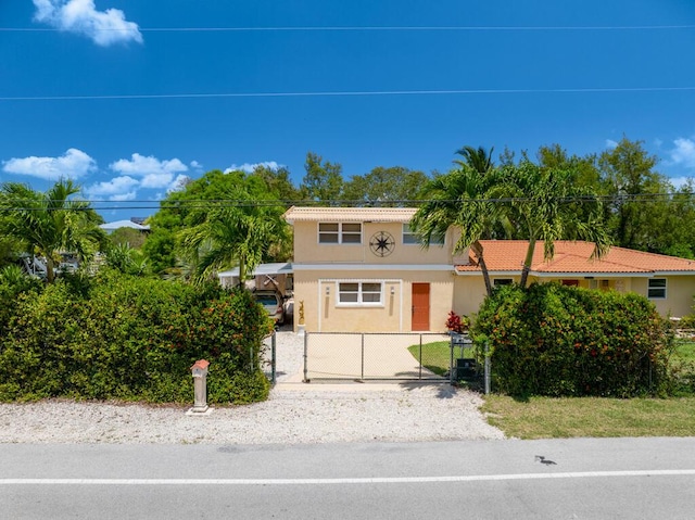 30985 Hibiscus Dr, Big Pine, FL 33043 - view of front of home featuring stucco siding, a gate, and a fenced front yard