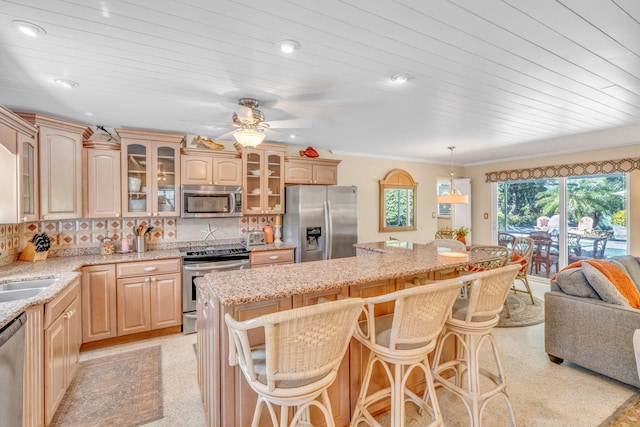 30985 Hibiscus Dr, Big Pine, FL 33043 - kitchen featuring stainless steel appliances, a center island, a breakfast bar area, a ceiling fan, and recessed lighting