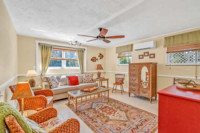 30985 Hibiscus Dr, Big Pine, FL 33043 - living room with a wall mounted air conditioner, a ceiling fan, light tile patterned floors, and a textured ceiling