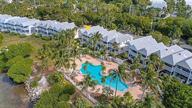 5081 Sunset Village Dr, Duck, FL 33050 - aerial perspective of suburban area featuring a pool area and a tree filled landscape