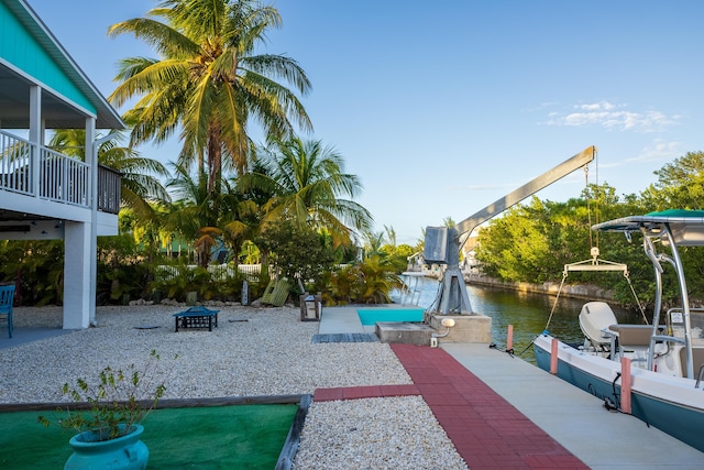 view of property's community with a dock and a water view