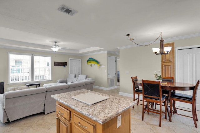 437 Pirates Rd, Little Torch, FL 33042 - kitchen featuring light tile patterned floors, ornamental molding, light countertops, a center island, and open floor plan