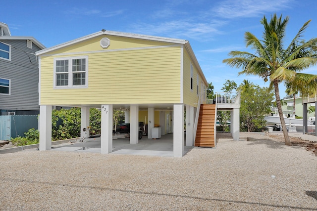 437 Pirates Rd, Little Torch, FL 33042 - view of front facade featuring stairway, a carport, and driveway