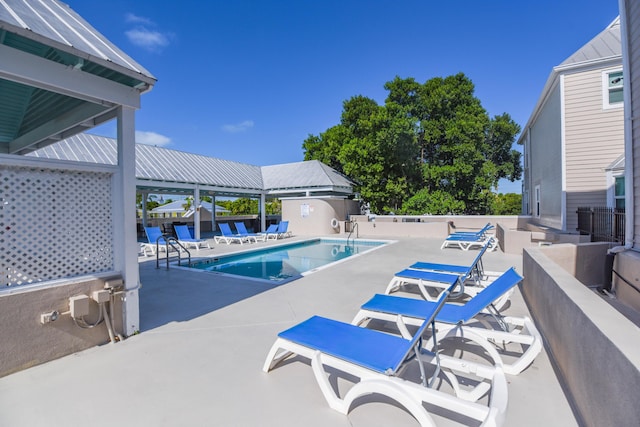 community pool featuring a patio area and fence