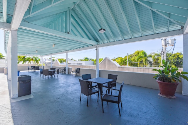 view of patio with outdoor dining space and fence