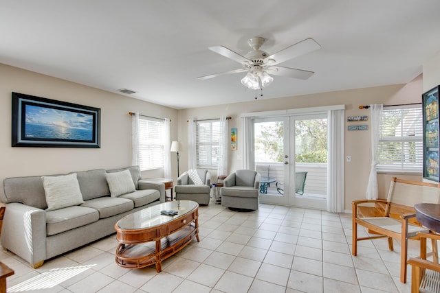 living room with light tile patterned floors and a ceiling fan