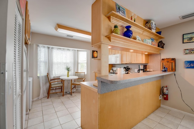 kitchen with white appliances, open shelves, light tile patterned flooring, a peninsula, and baseboards