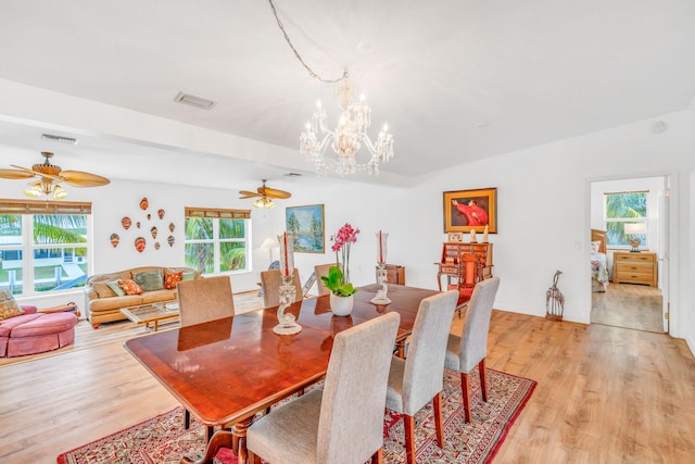 dining area featuring lofted ceiling, visible vents, and light wood-style floors