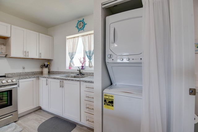 10877 Overseas Hwy Unit 81, Marathon, FL 33050 - laundry area with stacked washer / dryer and light wood finished floors