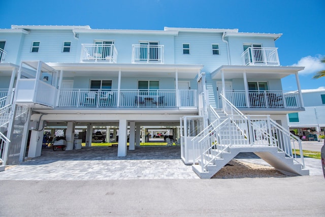 10877 Overseas Hwy Unit 81, Marathon, FL 33050 - back of house featuring a carport, driveway, stairs, and a balcony