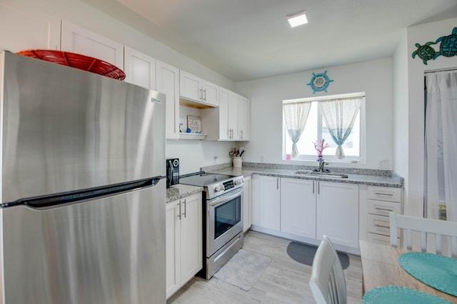 10877 Overseas Hwy Unit 81, Marathon, FL 33050 - kitchen featuring appliances with stainless steel finishes, a sink, white cabinets, and open shelves