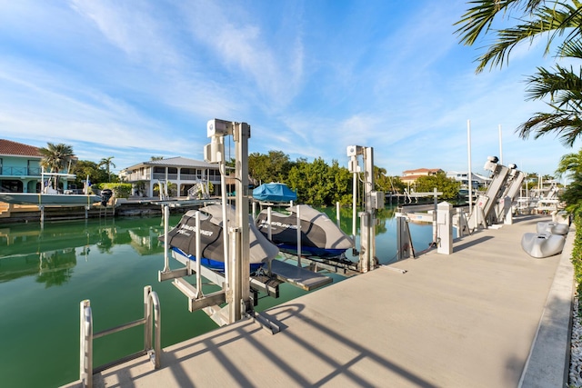 dock with boat lift and a water view
