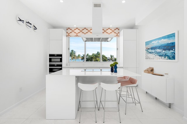 dining space with recessed lighting and baseboards