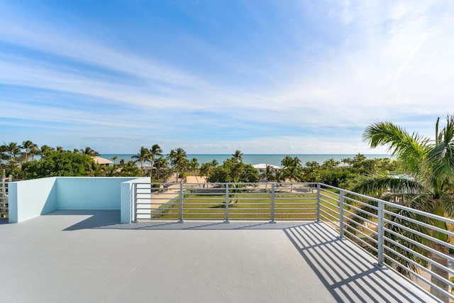 view of patio with a balcony and a water view