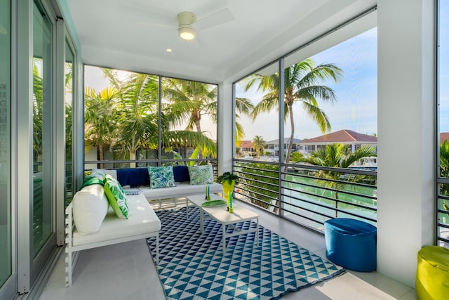 sunroom featuring plenty of natural light and a ceiling fan