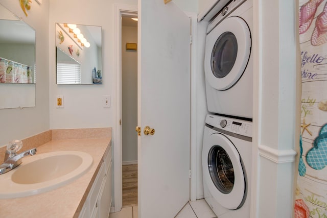 22878 Privateer Dr, Cudjoe, FL 33042 - laundry area featuring stacked washer / drying machine and light tile patterned floors