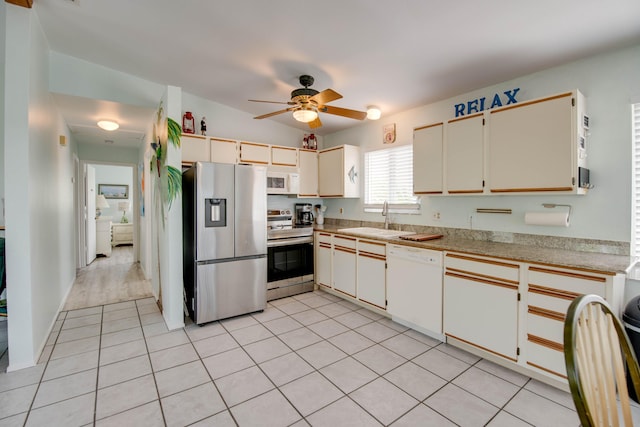 22878 Privateer Dr, Cudjoe, FL 33042 - kitchen with stainless steel appliances, ceiling fan, light countertops, and light tile patterned floors