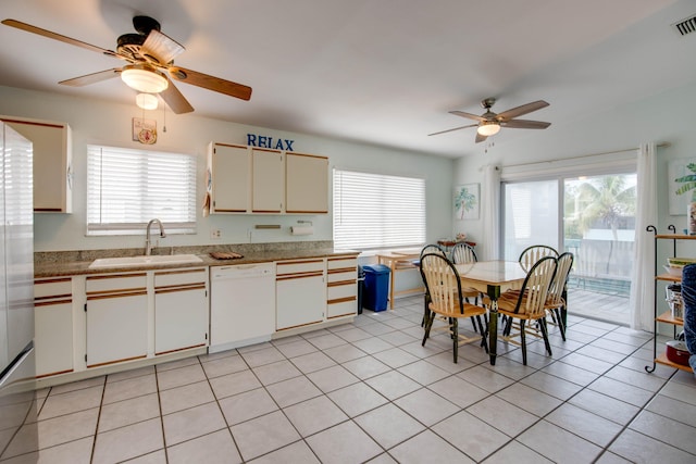 22878 Privateer Dr, Cudjoe, FL 33042 - kitchen with dishwasher, ceiling fan, plenty of natural light, and light tile patterned floors