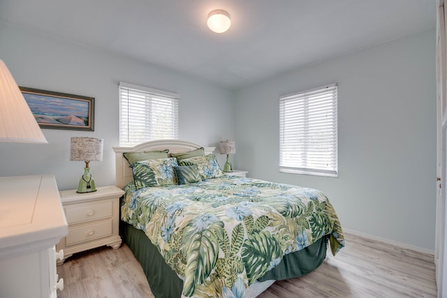 22878 Privateer Dr, Cudjoe, FL 33042 - bedroom with multiple windows and light wood-style floors
